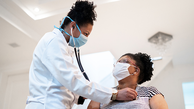 masked doctor with patient