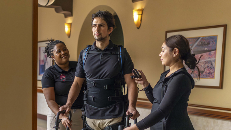 man walking with nurse assistance