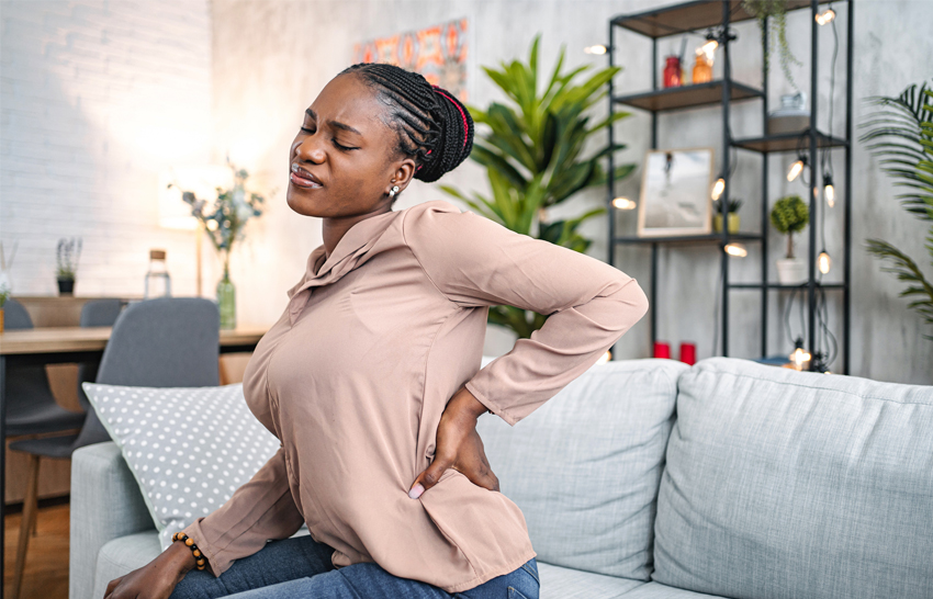 Woman holding her back in back paiin