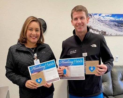 Justin Dye, MD and Elizabeth Santillan, LVN holding award