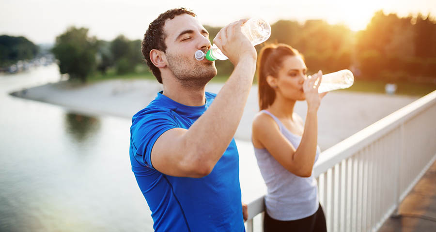 Couple drinking water after a run