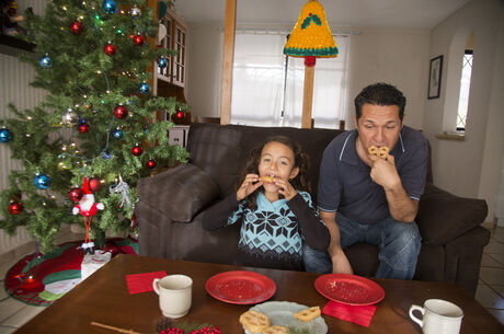 Father and daughter, taking Christmas snack 