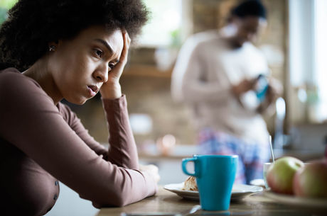 Displeased black woman having problems during morning in the kitchen. - stock photo