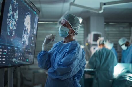 Professional Focused Caucasian Female Surgeon Reviewing Patient&#039;s Brain Scans