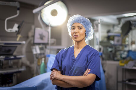 Dr. Andrea Salcedo stands facing camera in operation room