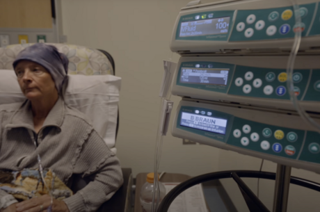 a woman sits in a chair while receiving a medical treatment 