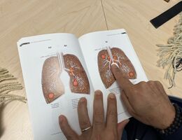 a man points to a picture of lung