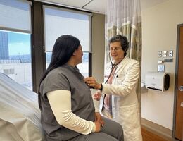 A doctor examines a patient&#039;s heart using a stethoscope. 