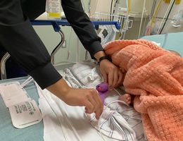 Baby&#039;s foot used to check blood pressure by nurse in hospital