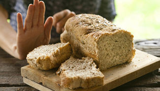 Hand pushing away bread 