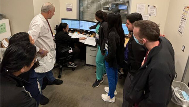 students gathering around computer