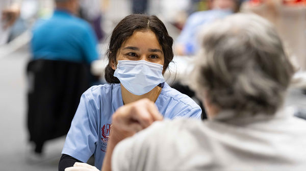 medical assistant talking with patient about