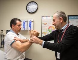 Doctor testing strength on patient