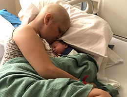 cancer patient holding her newborn child