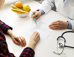 Doctor showing person a paper
