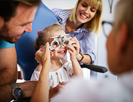 ophthalmologists putting glasses on a child