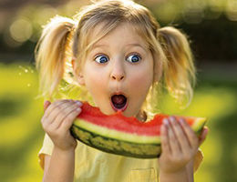 child girl eating watermelon