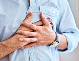 Man clutching chest in pain