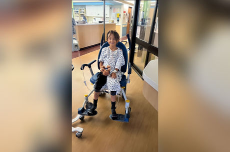 Samuel Rodriguez smiles in wheelchair at hospital 