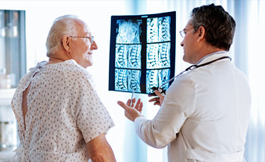 Doctor looking at spine scan 