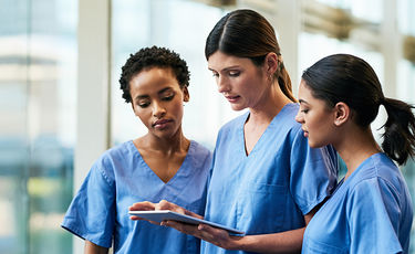 nurses looking at a tablet