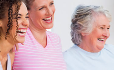 Three happy generational women together smiling