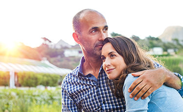 couple hugging in field