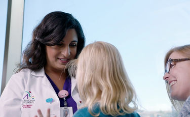 Female doctor with patient and friend