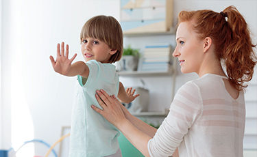 woman testing child for pain on back