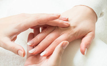 doctor examining someones hand for nerve damage