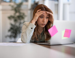 woman frustrated looking on laptop