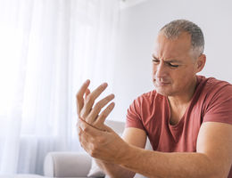 man in pain holding his wrist