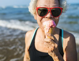 women enjoying ice cream on the beach