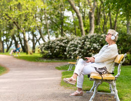 Women sitting on park bench happy and relaxed