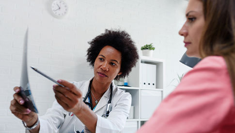 Woman talking with doctor about screening results