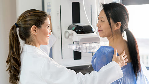 woman getting a mammogram from female doctor