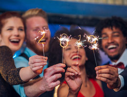 group of four holding 2019 sparklers