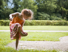 female child looking at her foot