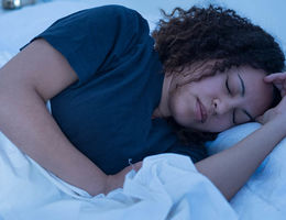 Young woman having difficulty sleeping due to nerve pain.