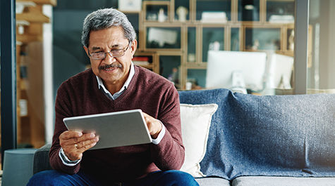 man reading newsletter on tablet