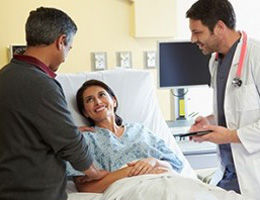 doctor talking to patient and spouse