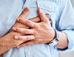 Man clutching chest in pain